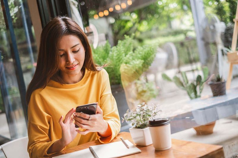 Photo of Woman Using Smart Phone