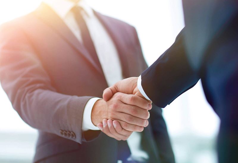 Photo of People in Suits shaking hands